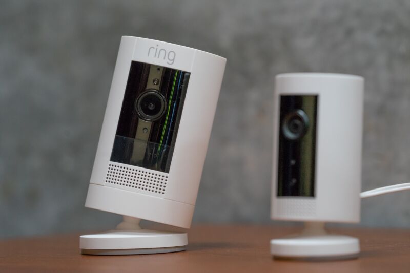 Two Amazon Ring cameras sitting on a table.